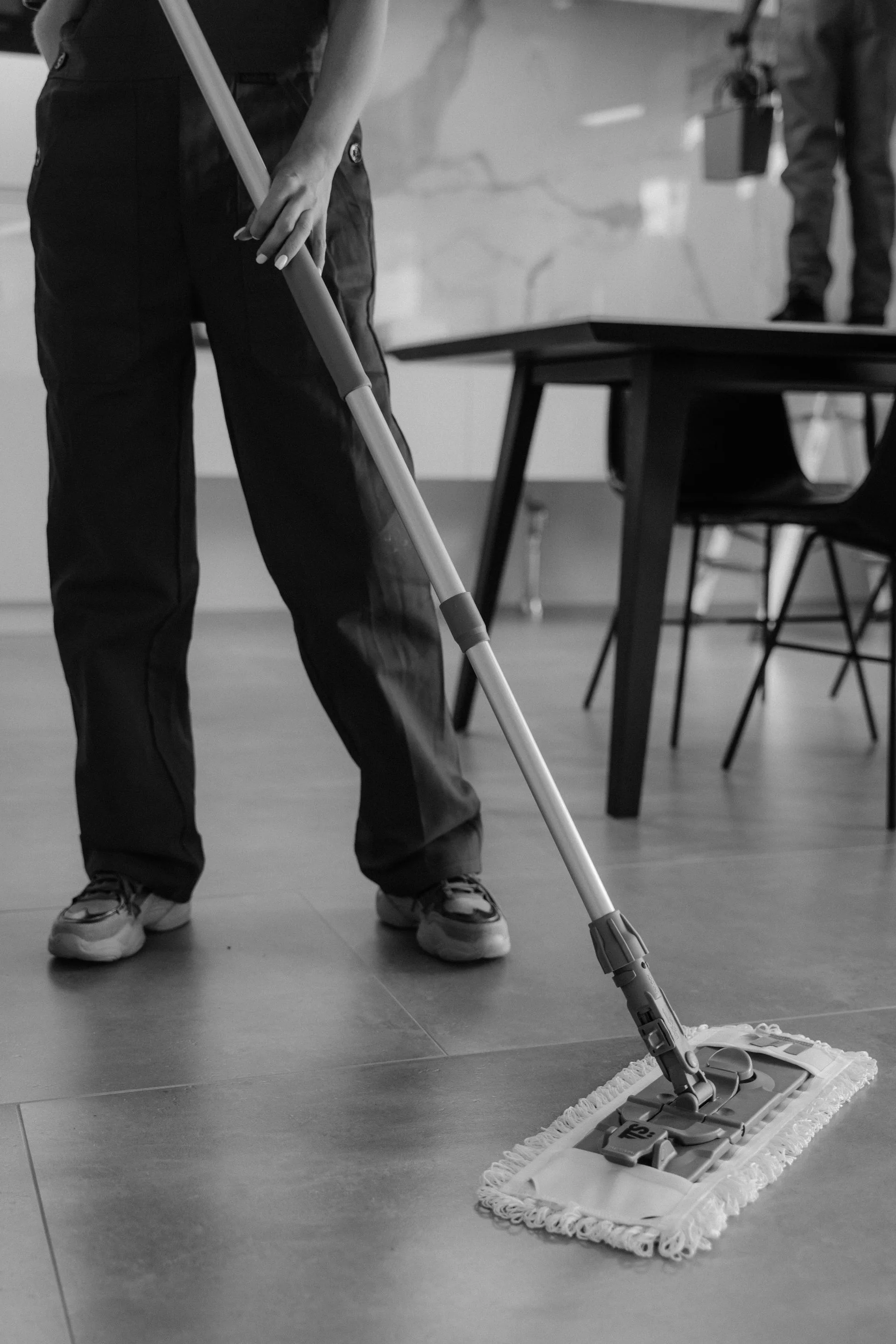 Professional cleaner mopping a tiled floor