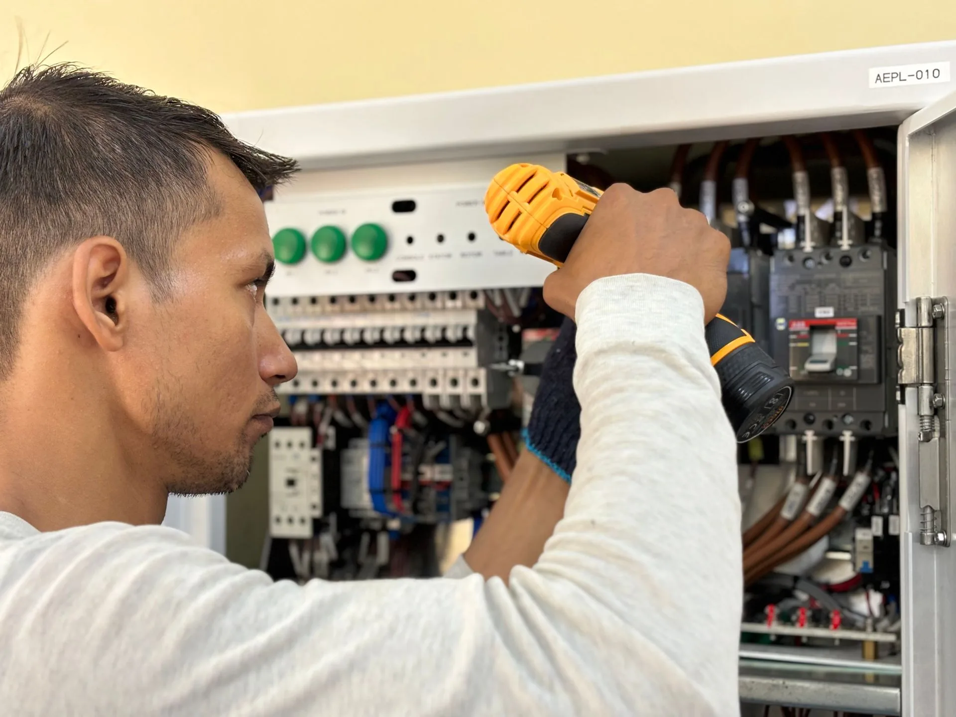 Technician working on an electrical distribution panel